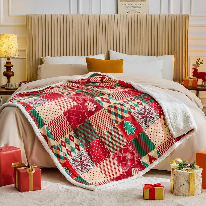 Christmas-themed patchwork quilt on a bed with decorative gifts around.